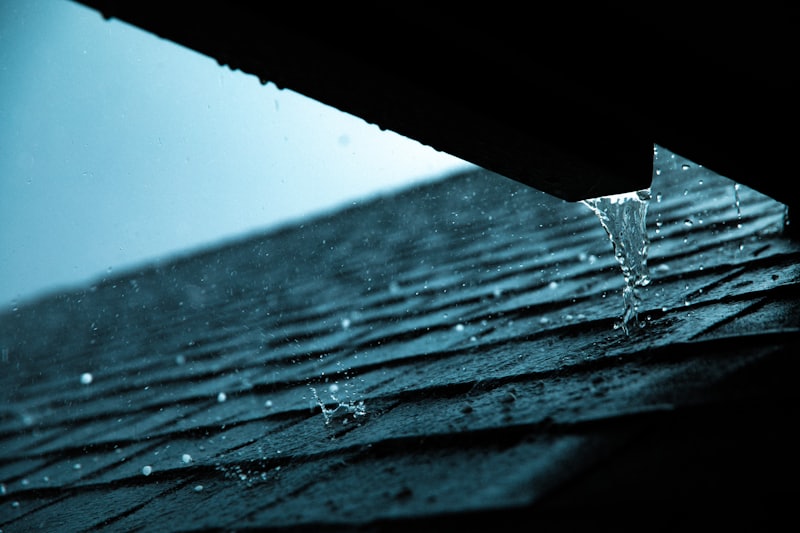 Close view of a roof edge and gutter during preventive roof maintenance