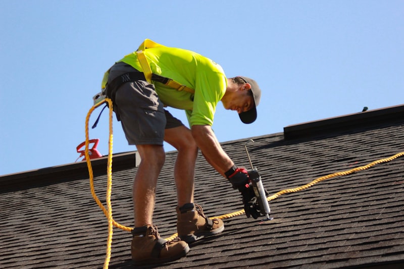 Roofing contractor performing a shingle roof repair